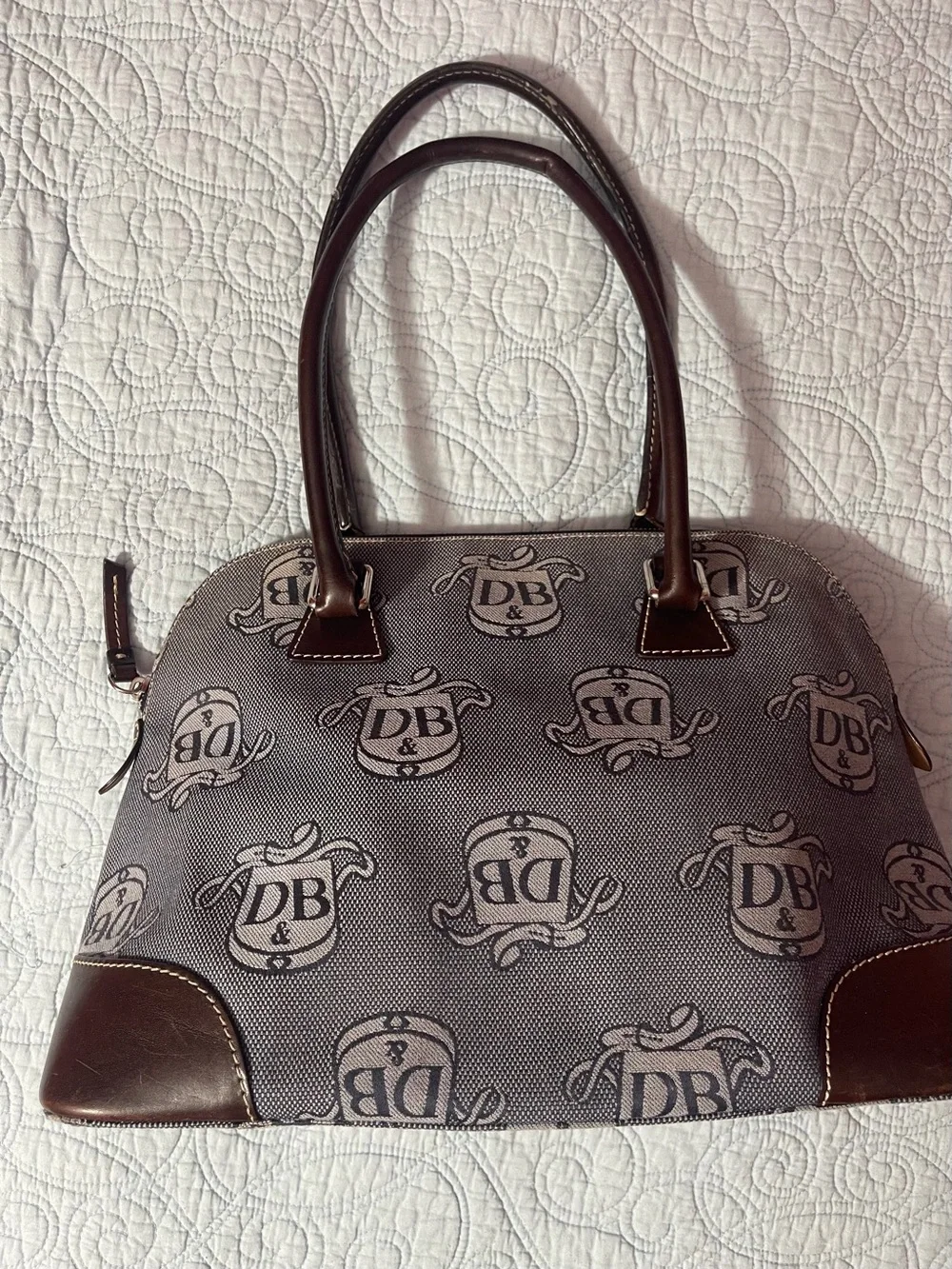 Dooney and Bourke Monogram Denim Donegal Dome Satchel with brown leather trim.